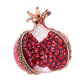 Decorative pomegranate with gold accents on a white background